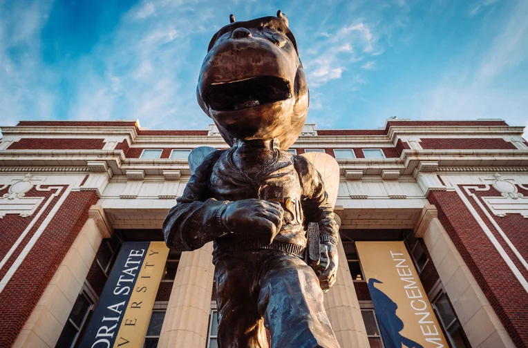 Emporia State mascot, Corky, in front of Plumb Hall