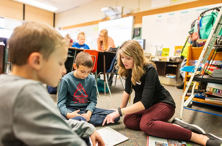 Student Teacher in the Elementary Education program reading to elementary student