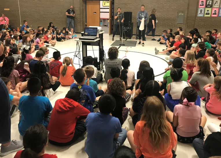 Students sitting in circle at elementary school