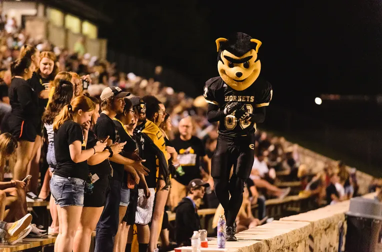 Corky with students at Hornet football game