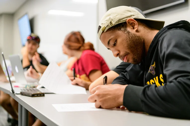 Student taking notes during class