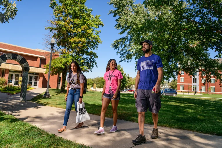 Students walking across lawn