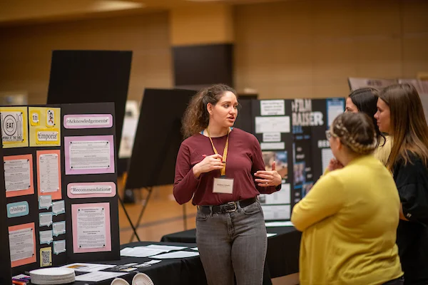 Student discussing poster presentation at Emporia State University's Research & Creativity Day