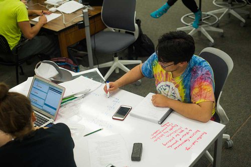 Equipment in ACES, like this table with a dry-erase surface, make it easy for students to collaborate. 