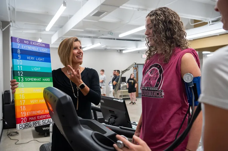 Students interacting with a professor in the Doc Baxter Lab