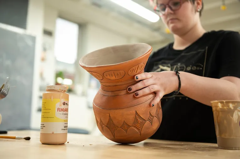Student working with Potery