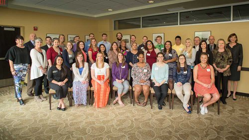 Students who are receiving scholarships from the Jones Foundation join trustees of the organization in a celebration. 