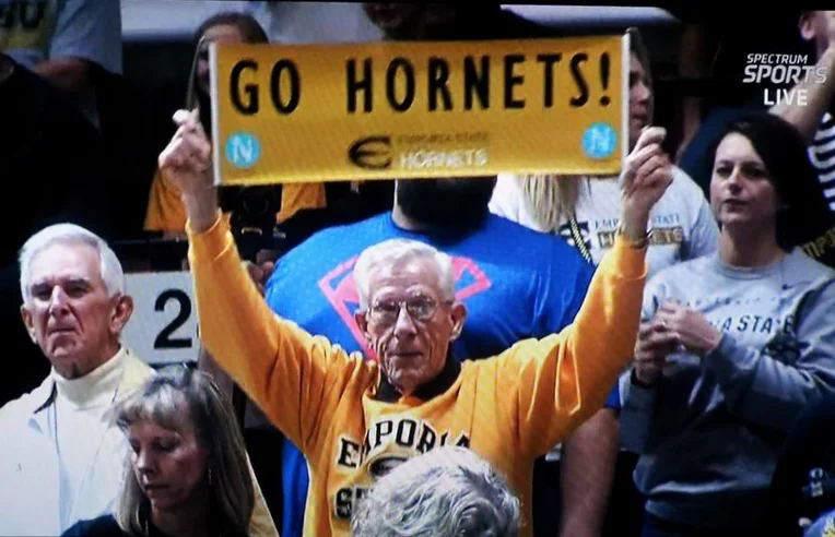 Robert Chatham holding a Go Hornets sign at an ESU game