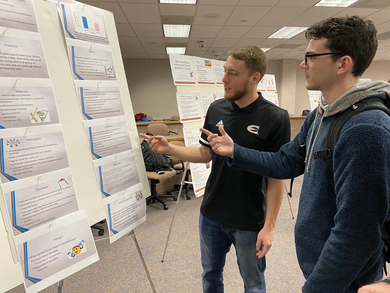 Emporia State Psychology students discussing poster presentation