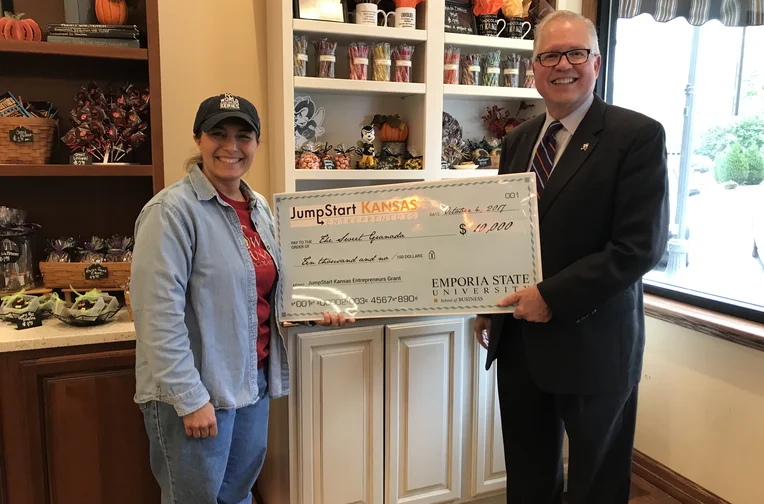 Ed Bashaw poses with check from JumpStart Kansas