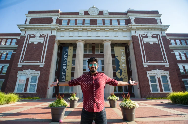 Student in front of Plumb Hall