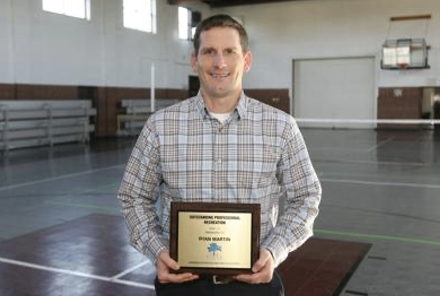 Ryan Martin holding an award