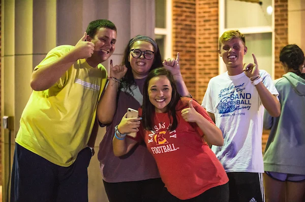 Group of students giving stingers up gesture