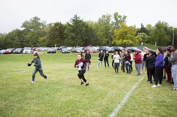 Emporia State students running on field