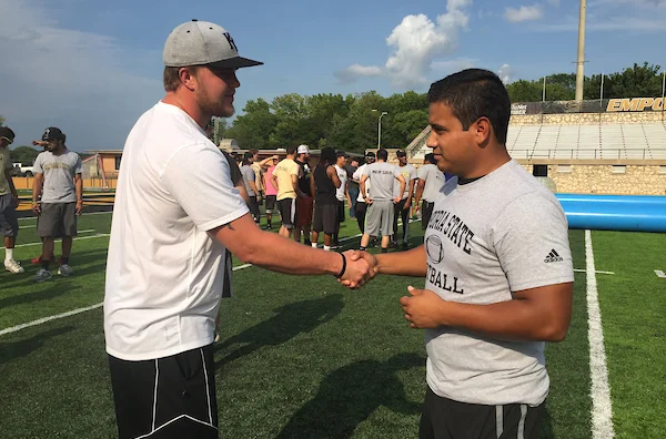 Emporia State students shaking hands