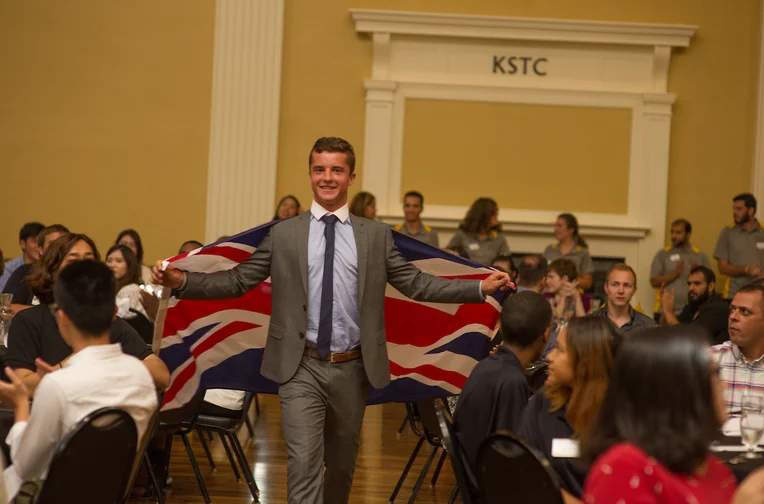 Student walking carrying flag