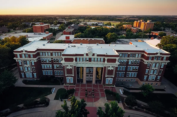 An aerial photo of Emporia State University focuses on a brick building with white columns.