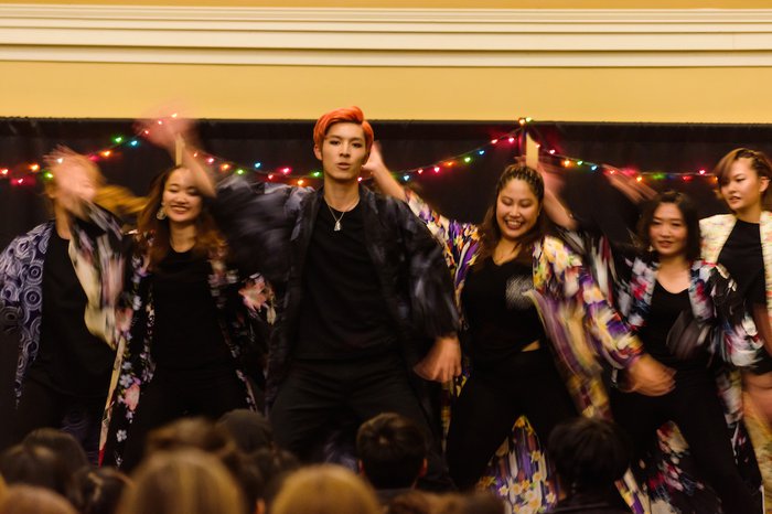 Students dance in colorful costumes