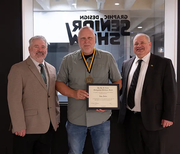 Three men standing side by side facing the camera.