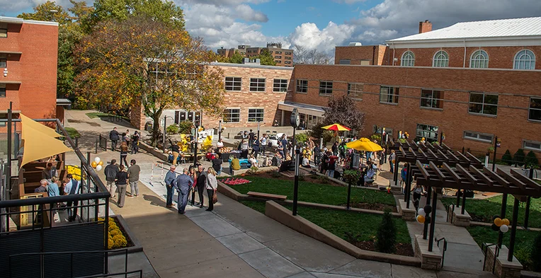 An overhead shot of a gathering space with groups of people visiting.