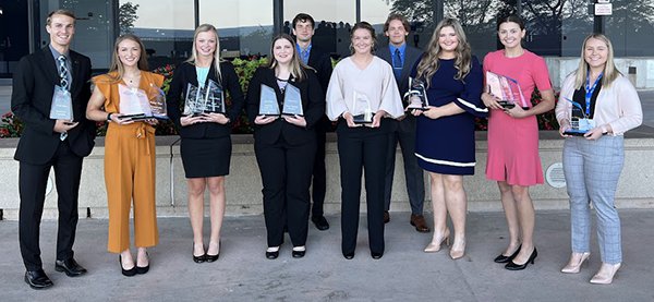 Group of 10 students holding awards