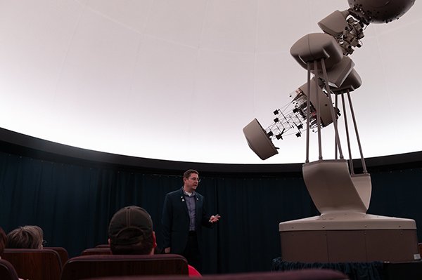 Man stands in front of projection screen